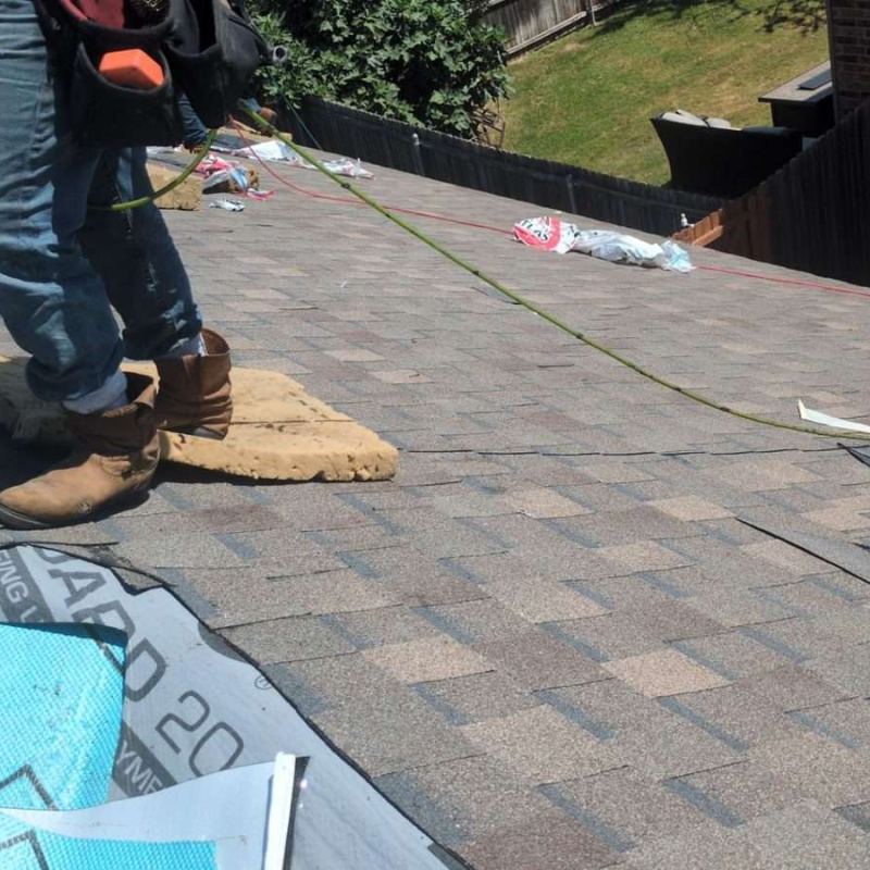 American Prime General Construction installing synthetic underlayment during a roof replacement